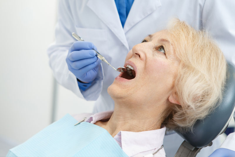 Dental Patient Having Her Mouth Inspected